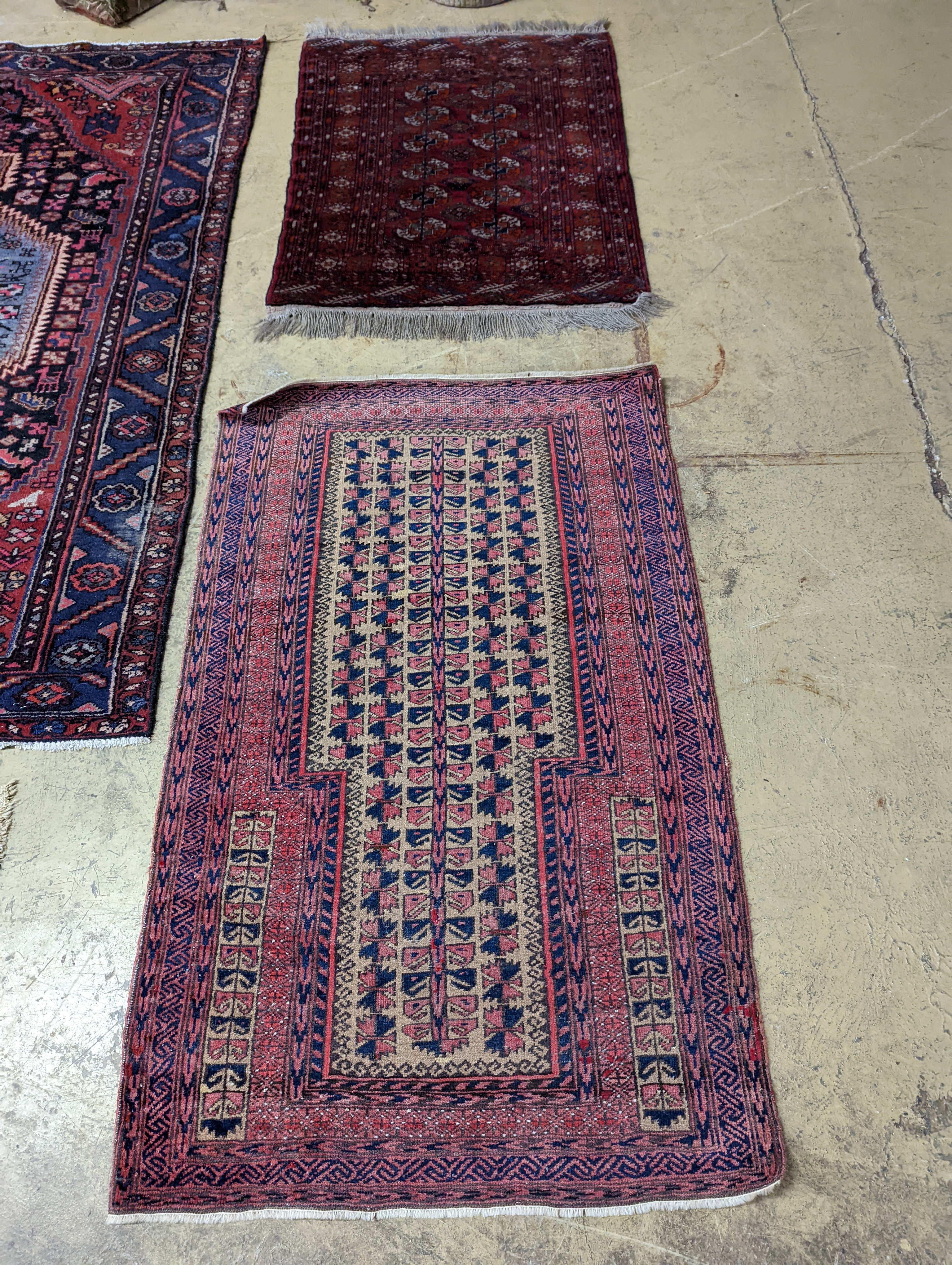 A Bokhara red ground rug and a Belouch prayer rug, larger 144 x 88cm